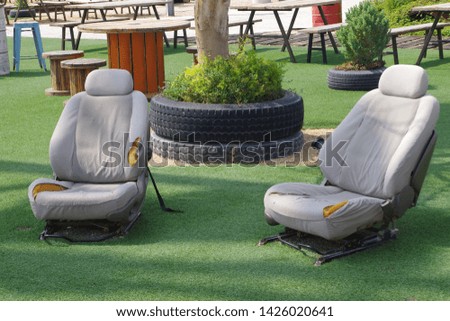 Picture of a successful recycling of two old car chairs installed freely in a garden.