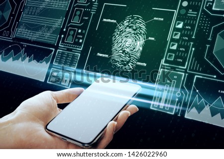 Hand holding smartphone with creative finger print scan hologram on blue background. ID and safety concept. Multiexposure 