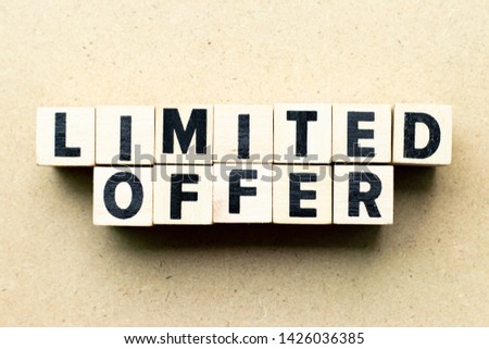 Letter block in word limited offer on wood background