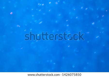Blurred background - blue sparkles. Abstract image. Bright color. Abstract circular bokeh.