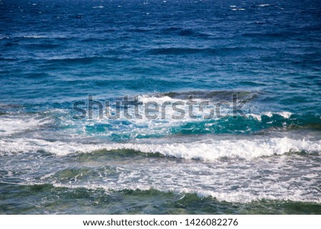 Blue clear water. Beautiful blue sea wave photograph close up. Beach vacation at sea or ocean. Background to insert images and text.