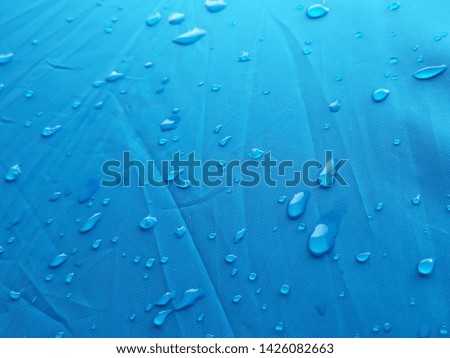 Blue rain tarpaulin prevents rain drops