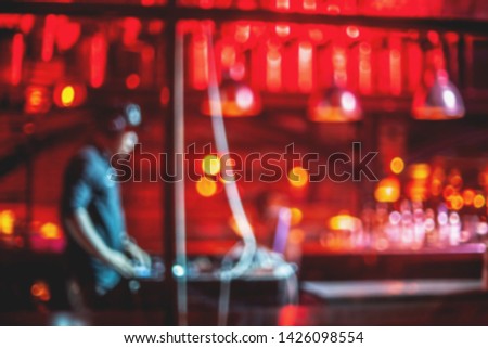 Lighting in club party,blur silhouettes of happy people crowd having fun and dancing in club party.
