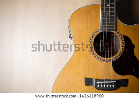 Closeup acoustic guitar on brown background. Acoustic guitar that is classic and beautiful