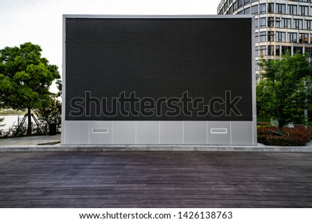 a large outdoor LED billboard on the city square