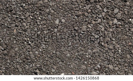 texture and background of black gravel on the street in the summer