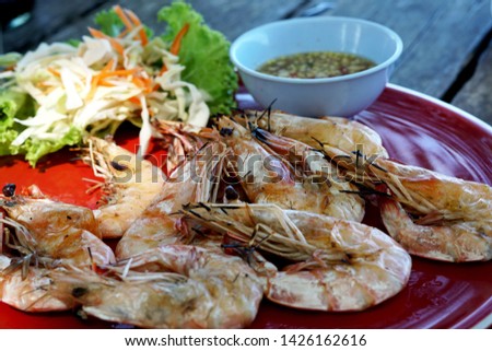 Grilled shrimps with seafood spicy sauce on the table. 