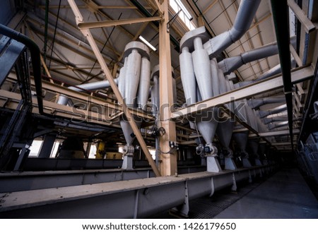 Interior of modern natural oil factory. The piping, pumps and motors. Industry background