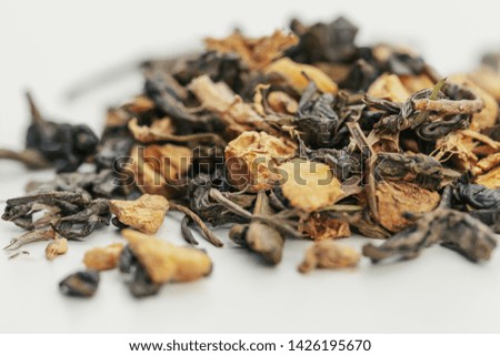 Dried tea leaves close up on white background