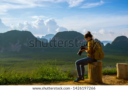 Young woman travels to take pictures of nature on the mountain. Travel adventure. Landscape Beautiful Mountain on sea at Samet Nangshe Viewpoint. Phang Nga Bay, Travel Thailand, summer holiday.