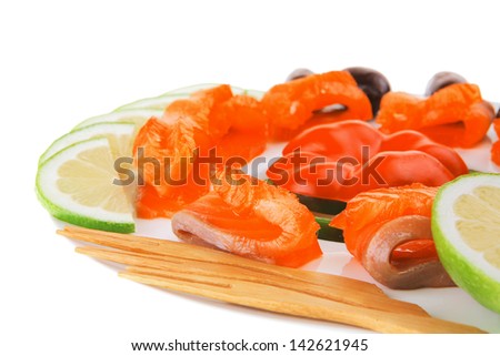 fresh smoked salmon slices on white with olives