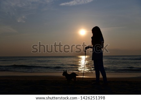 The shadow of the people in front of the sea in the sunrise