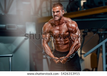 Body Builder Workout at the Gym. Performing Cross Over Exercise for Chest Muscles Royalty-Free Stock Photo #1426313915