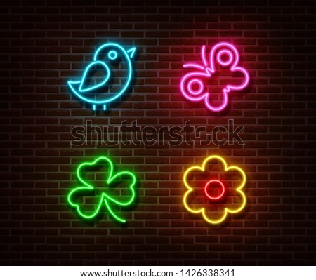 Neon bird, butterfly, shamrock, flower signs vector isolated on brick wall. Nature light symbols, decoration effect. Neon  illustration.