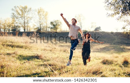 Happy young couple walk together with love and friendship. forever life and positive vibes concept with logn way road and jump for happiness. family married style