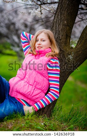 Teen girl in the garden bloom trees