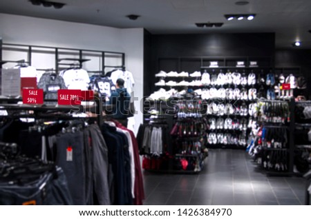 Blurred sport store background with sale red sign