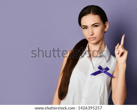 Woman pointing finger up reminds about the importance with purple ribbon to world epilepsy day, cancer day, Epilepsy and fibromyalgia awareness