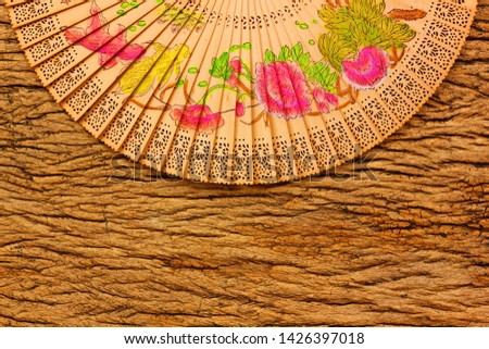 vintage Chiness fan on retro wood background