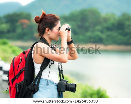 Asia woman traveler hiking travel backpack enjoying with binoculars and camera, lifestyle concept beautiful mountains landscape on background summer journey adventure vacations outdoor