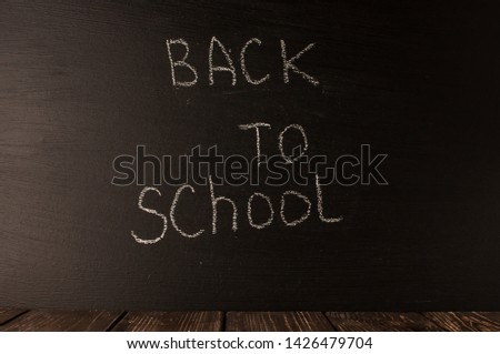 Back to school, the concept of parenting. The inscription on the blackboard with white chalk. Place for text. Copy space.