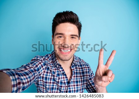 Closeup photo portrait of handsome positive cheerful he guy having free time video call making selfie give v-sign to viewers followers isolated pastel background