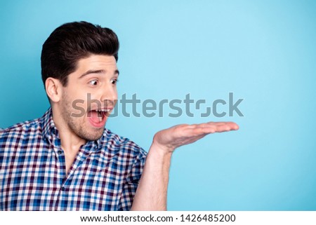 Close up photo amazing he him his macho hold raise open hand arm novelty unbelievable great offer proposition crazy big eyes mouth wear casual checkered plaid shirt isolated bright blue background