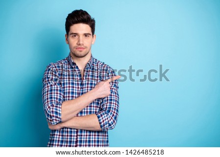Portrait focused thoughtful classy youth feedback adverts choose decide recommend tip suggest pick option present display look attention information plaid clothing spring isolated blue background