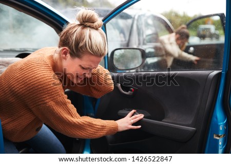 Female Motorist In Crash For Crash Insurance Fraud Getting Out Of Car Royalty-Free Stock Photo #1426522847