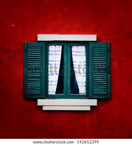 Vintage window on red cement wall