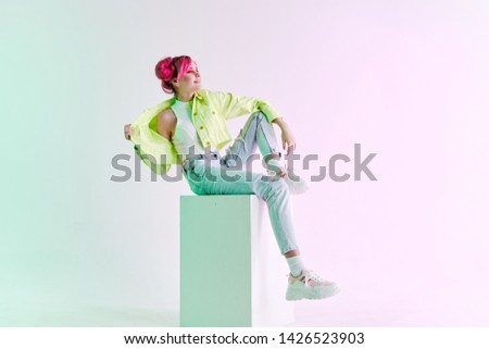 woman in stylish trendy clothes with pink hair sitting