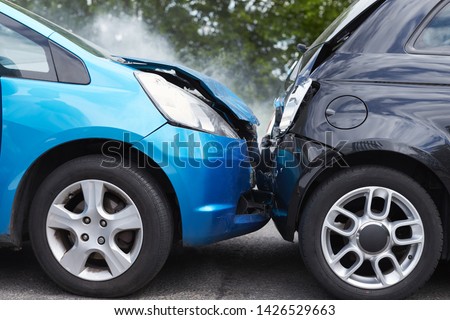Close Up Of Two Cars Damaged In Road Traffic Accident Royalty-Free Stock Photo #1426529663