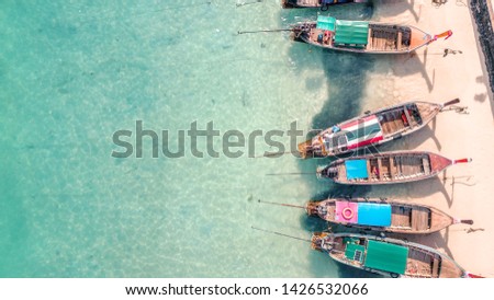 Drone shot of long tail boats in Maya bay in Thailand, the beach and national park is now closed to tourists to help regenerate damaged sea bed, and land ecosystems.