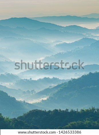 Beautiful Landscape of mountain layer in morning sun ray and winter fog at Doi Hua Mae Kham, Mae Salong Nai, Chiangrai, Thailand