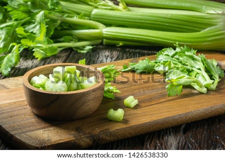 Sliced fresh celery or Celery stalk on cutting wooden board Royalty-Free Stock Photo #1426538330