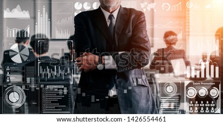 Big Data Technology for Business Finance Analytic Concept. Modern graphic interface shows massive information of business sale report, profit chart and stock market trends analysis on screen monitor. Royalty-Free Stock Photo #1426554461