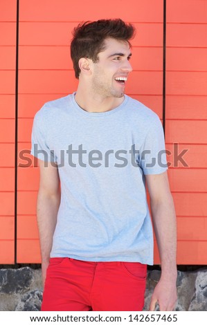 Portrait of a handsome young man smiling and looking away