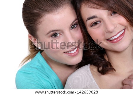 Two female friends hugging.