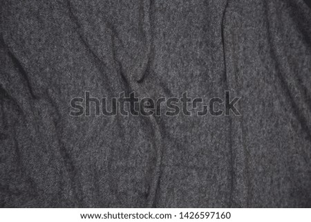 Wrinkles on dark gray elastic fabric, texture .