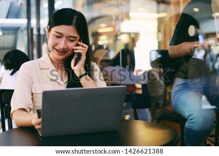 Smart Asian woman working in coffee shop.