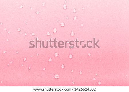 Drops of water on a color background. Pink. Toned.