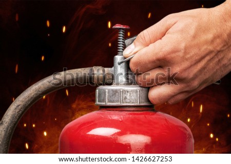 A firefighter uses a fire extinguisher during a fire