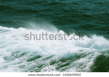 Blue water on the surface of the Pacific Ocean. Natural background. Toned.