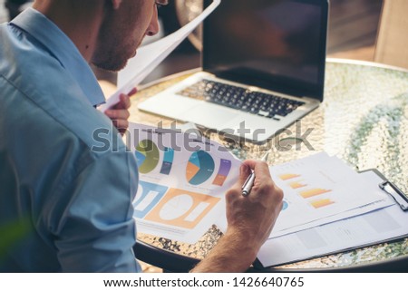 Business man viewing summary and annual report at office.Financial adviser planning and pointing at document and discussion on mistake work.Business man and account concept