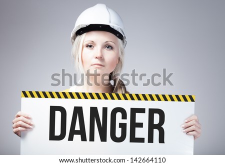 Danger sign held by a worker