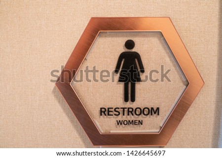 The women restroom sign stick on the wall.
