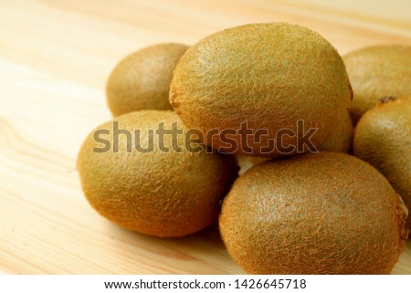 Closeup Heap of fresh kiwi fruits isolated on the wooden table
