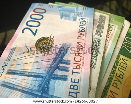 
Russian new banknotes 200 rubles, 2000 rubles and old banknotes 1000 rubles. Close-up. Scattered fan banknotes. Cash, currrency, banknotes bank Russia. Finance and business concept. 