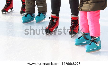 feet of different people skating on the ice rink. sports, Hobbies and recreation of active people

