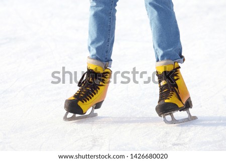 Female legs in skates on an ice rink. sports, Hobbies and recreation of active people


